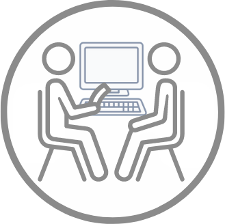 Decorative Image - "Two people sitting at a table with a computer, one holding a document, engaging in one-on-one counseling and the other person listening."